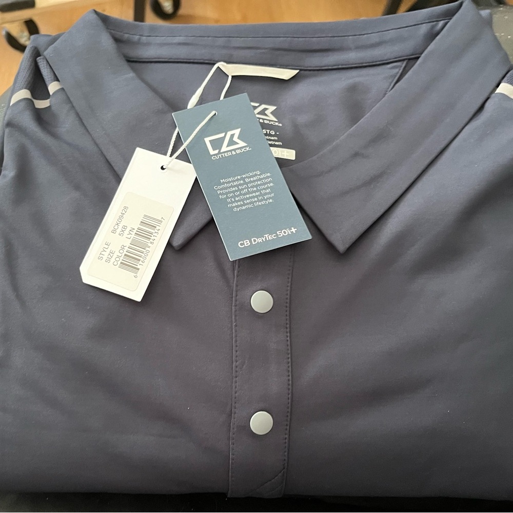 Cutter&Buck polo. Dark navy blue. Stripes on the shoulders.  Sun protection.